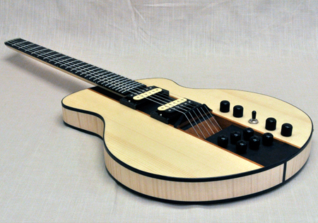 Headless hollow body electric guitar. Euro spruce, curly maple, african mahogany and ebony.